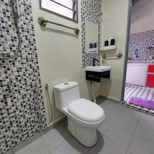 a bathroom with a toilet and a shower and a sink at Laman Sakinah Merlimau in Merlimau