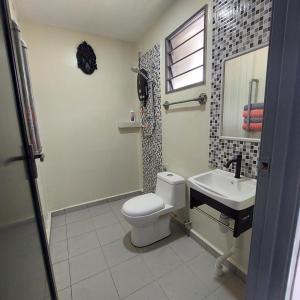a bathroom with a toilet and a sink at Laman Sakinah Merlimau in Merlimau