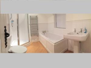 a bathroom with a sink and a toilet and a shower at Tickeridge Farm in Hanley Castle