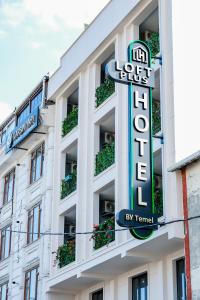 a building with a sign for a hotel at Loft Plus Hotel's in Arnavutköy