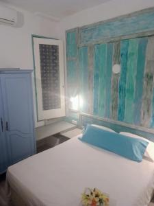 a bedroom with a white bed and a window at Casa Violette in Almería