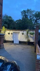 a garage with a car parked in a driveway at Riverside Cottage in Kent