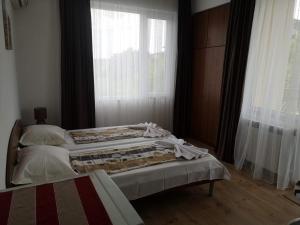 a bedroom with two beds in front of a window at Miraj-MD in Primorsko