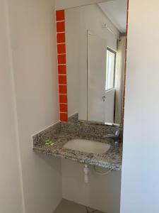 a bathroom with a sink and a mirror at Senhor Hotel in Juazeiro do Norte