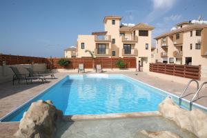 a large swimming pool in front of a house at Artemis Executive Suite in Larnaca