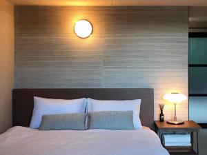 a bedroom with a large bed with a wooden headboard at Onhill Village in Pong Talong