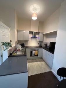 a kitchen with a sink and a counter top at Lovely One Bedroom Apartment in Rotherham