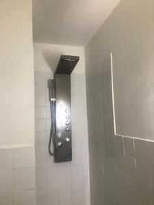 a shower with a shower head in a bathroom at Super location 1min from metro 10min from Camden in London