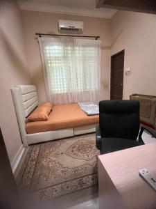 um pequeno quarto com uma cama e uma janela em Homestay Rohmat em Kota Bharu