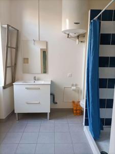 a bathroom with a white sink and a mirror at T2 centre village "Chez Clothilde" in Remoulins