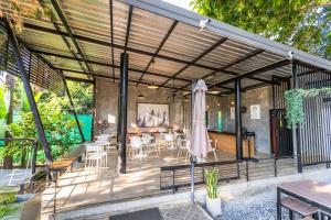 an open patio with a table and an umbrella at Onhill Village in Pong Talong