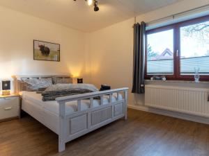 Ένα ή περισσότερα κρεβάτια σε δωμάτιο στο Ferienhaus mit Terrasse in St Peter-Ording