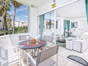 a patio with a table and chairs and a living room at Charming apartment in Mijas in Mijas