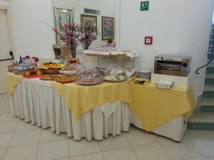 a table topped with plates of food at Hotel Mayor in Sperlonga