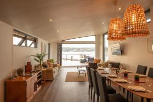 a dining room and living room with a long table at Houseboat Eleuthera in Bembridge