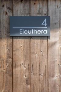 a sign on a wooden fence with the number four eighteen at Houseboat Eleuthera in Bembridge