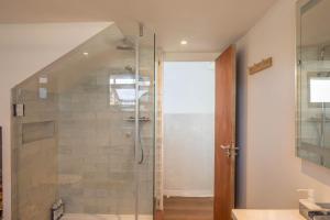a bathroom with a shower with a glass door at Houseboat Eleuthera in Bembridge