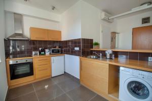 a kitchen with a washer and a dishwasher at Star Apartments with free parking in Budapest