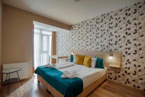 a bedroom with a bed with blue and yellow pillows at Star Apartments with free parking in Budapest