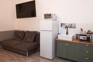 a living room with a couch and a white refrigerator at אחוזת רפאל in Tiberias
