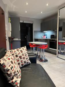 a living room with a couch and a table at Mandana in Évian-les-Bains