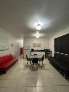 - un salon avec un canapé rouge et une table dans l'établissement Playa Apartments, à Salinas