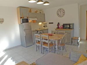 eine Küche mit einem Tisch und einem Kühlschrank in der Unterkunft Appartement Samoëns, 3 pièces, 5 personnes - FR-1-629-96 in Samoëns