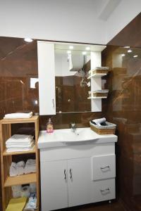 a bathroom with a white sink and a mirror at Vila Emma in Durrës