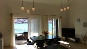 a living room with a table and a view of the water at Apartments Svjetlana in Trogir