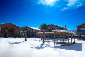 a resort in the snow with palm trees at Abant Sedir Park Butik Otel in Bolu