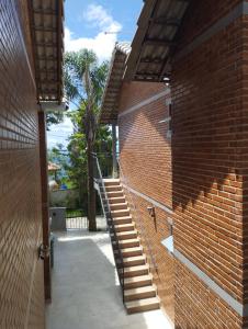 a brick building with a staircase and a brick wall at Chalés Estrada Real in Conceição da Ibitipoca