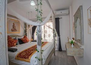 a bedroom with a canopy bed and a window at Fabulous Penthouse seaview wifi in Boutique resort in Hurghada