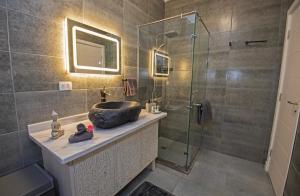 a bathroom with a sink and a glass shower at Fabulous Penthouse seaview wifi in Boutique resort in Hurghada