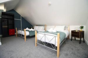 1 dormitorio con 2 camas en un ático en Stunning 4 Bedroom Flat near City Centre en Swansea