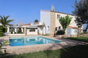 a villa with a swimming pool in front of a house at Casa Samsara Yaranda in Denia