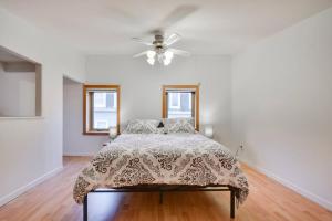 a bedroom with a bed and a ceiling fan at 2-storey house with garage and interior terrace in Quebec City