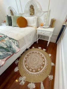 a bedroom with a bed and a table and a rug at Open Door Loft in Ponta Delgada