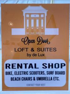 a sign for an open door lot and suites rental shop at Open Door Loft in Ponta Delgada