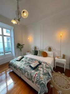 a bedroom with a large bed and a large window at Open Door Loft in Ponta Delgada