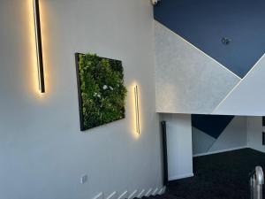 a room with a picture of a plant on the wall at Urban Pod Hotel Liverpool in Liverpool
