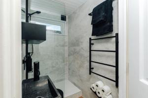 a bathroom with a sink and a shower at Cuckoo’s Hideaway in Buckinghamshire