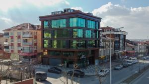a tall building with glass windows in a city at Loft Airport Hotel's in Arnavutköy