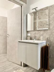 a bathroom with a sink and a mirror at LG LAKE - Boutique apartments and rooms - in Brienno