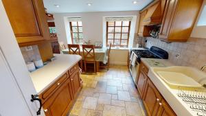 a kitchen with a sink and a stove top oven at Stables Barn in East Budleigh