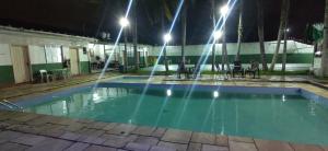 an empty swimming pool at night with lights at Pousada Praia Grande - Rua Ernesto Vergara ,511 in Praia Grande