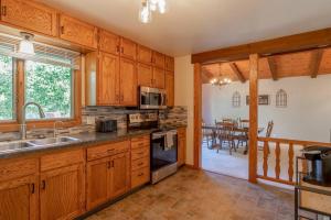 a kitchen with wooden cabinets and a dining room at Family Home W/ 2 King, 2 Queen Beds + Game Room in Bemidji