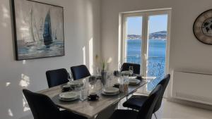 d'une salle à manger avec une table, des chaises et une fenêtre. dans l'établissement Villa Duchess, à Dubrovnik