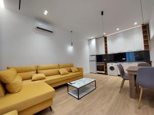 a living room with a couch and a table at Luxury apartments Blloku in Tirana