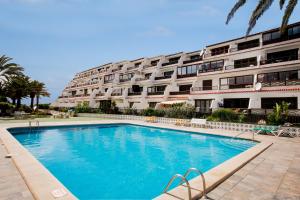 a large swimming pool in front of a building at 10A Amarilla Bay Pool Smart TV WI FI in Costa Del Silencio