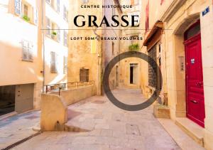 a book cover of a city street with a red door at Loft au bèu mitan - 50m2 in Grasse